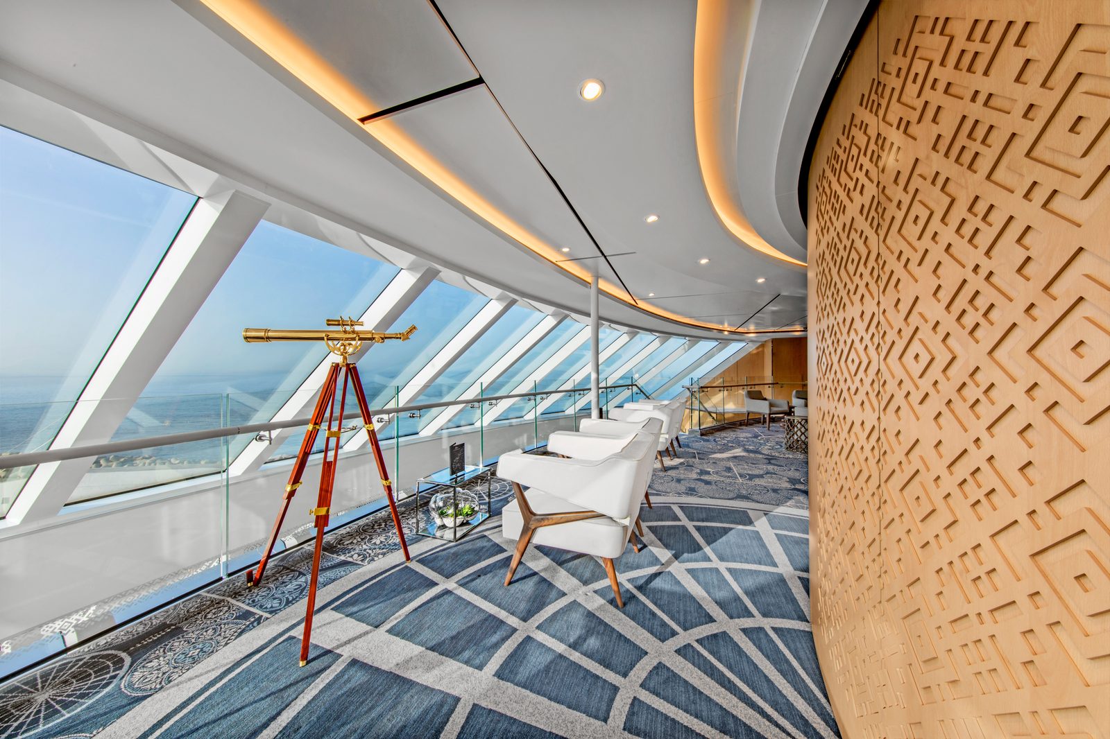 Explorers' Lounge aboard a Viking Ocean ship, with floor-to-ceiling windows overlooking the sea